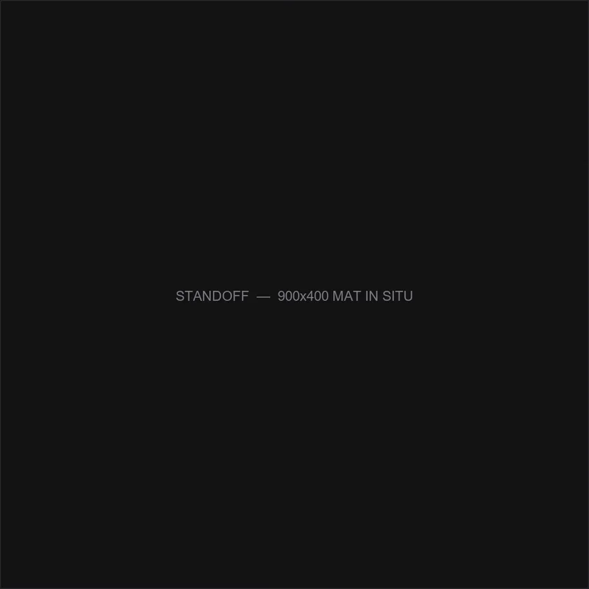 The Standoff desk mat, 900 by 400mm, shown on a desk.